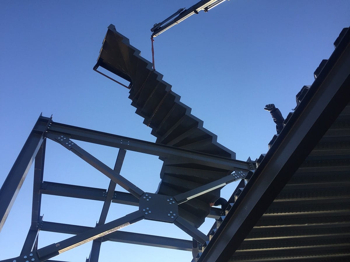 Lifting the steel stair by crane onto the vertical addition in Alimos