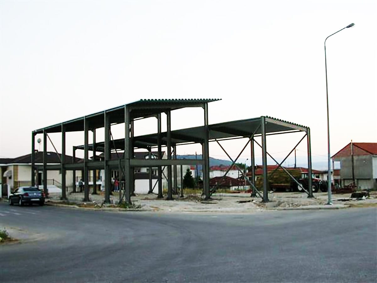 Two-story steel frame of a retail store nearing completion in Argos Orestiko