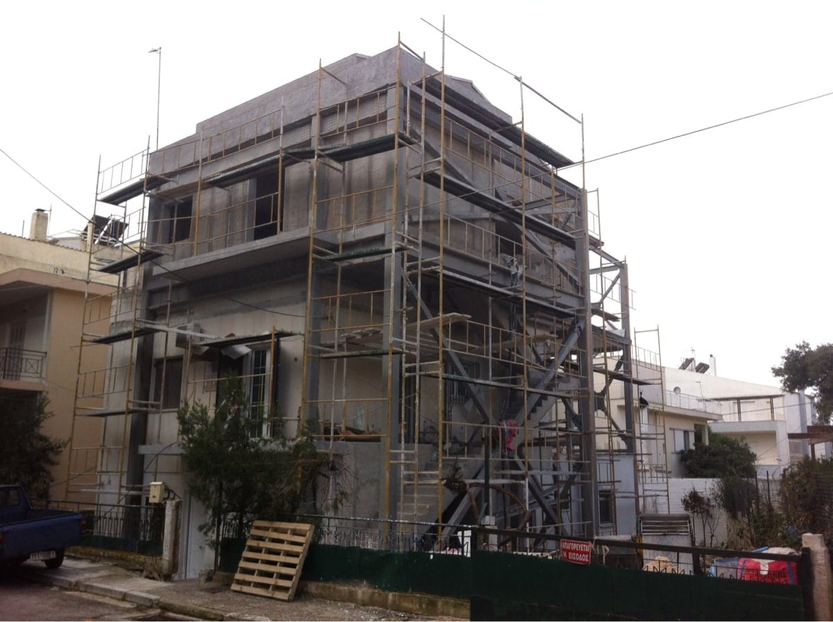 House extension with scaffolding during plastering in Melissia
