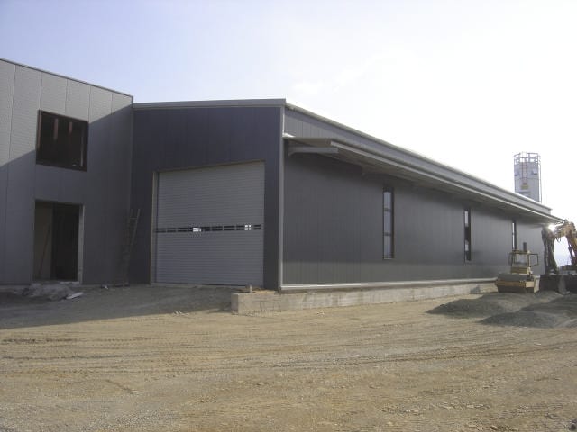 Completed steel building with insulated panels and an industrial door in Grevena