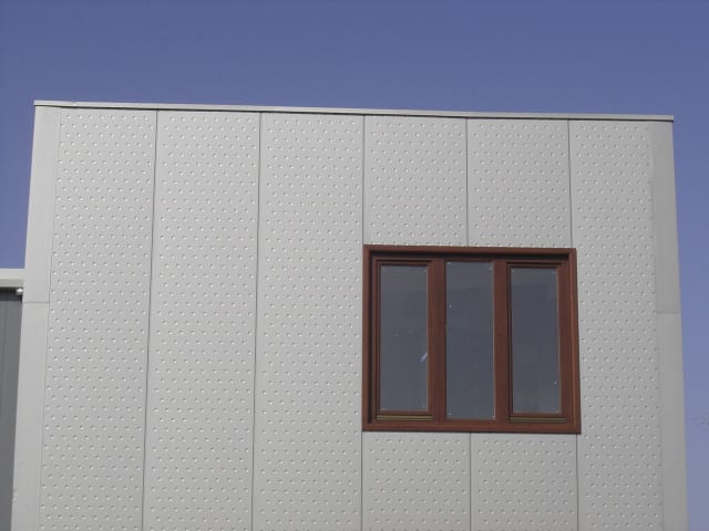 Facade detail with Bubble-type panels and a wooden window in Grevena