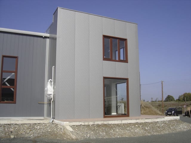 Bubble-type panels with wooden windows on the office wing in Grevena