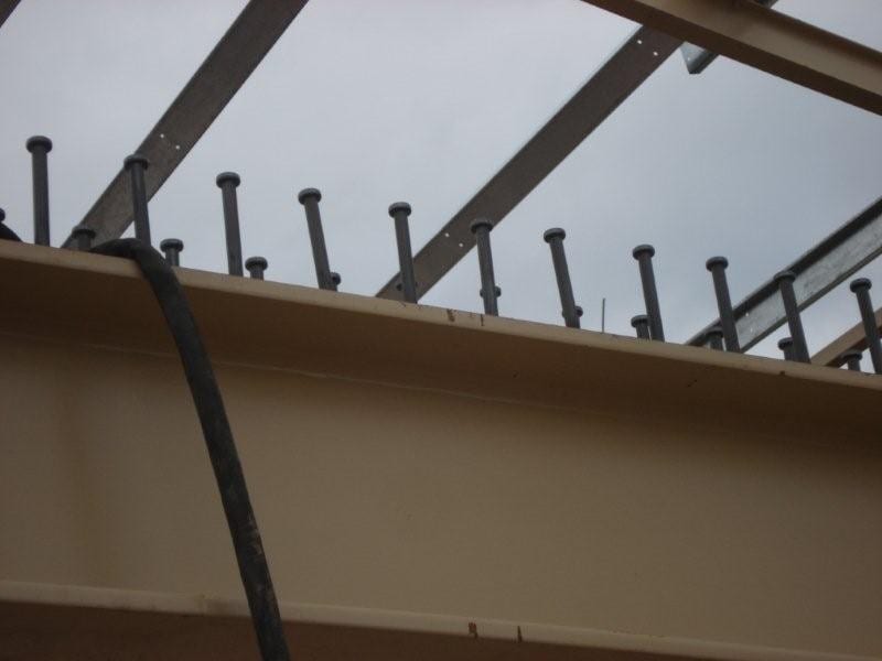 the studs on the beams, which make the slabs work as diaphragms, play the role that rebar anchorage plays in conventional construction
