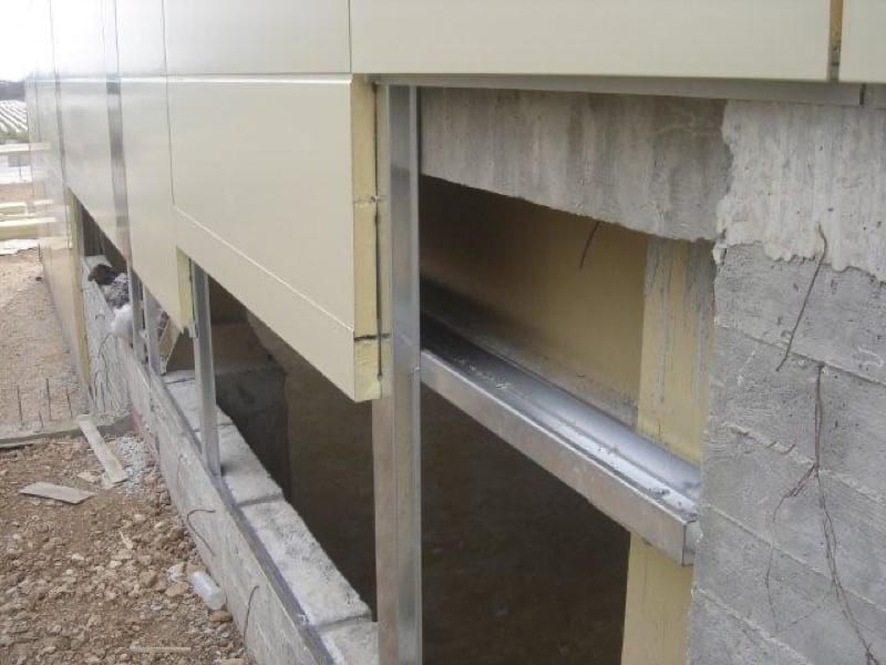 Serbond installation in progress. Covering the concrete for a uniform facade
