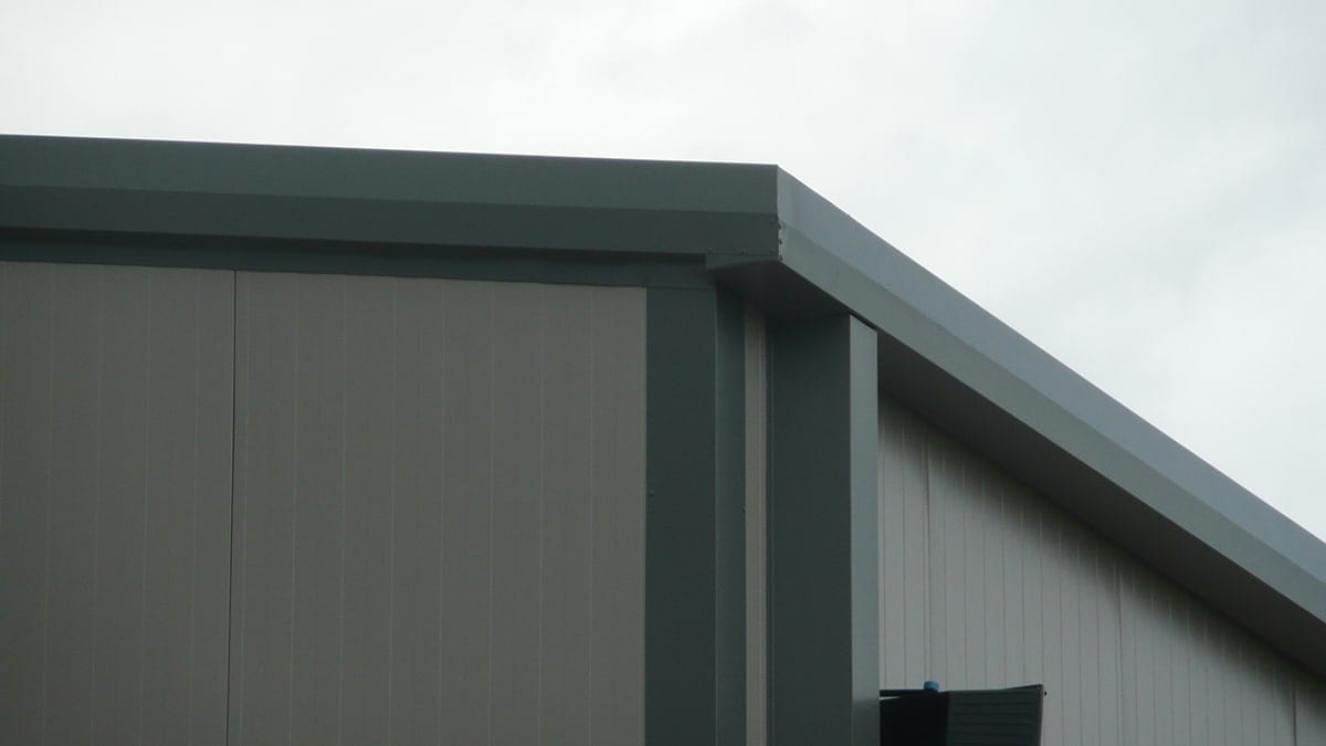 Detail of the sheet-metal flashings at the roof corner of the warehouse in the Ioannina industrial zone