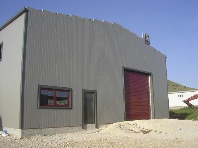 Elevation of the paper products workshop in the Ioannina industrial zone with panels and an industrial roll-up door