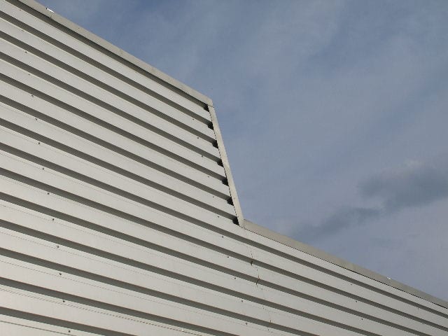 Detail of wall cladding with horizontal metal sheet at the Modeco showroom in Asprochoma