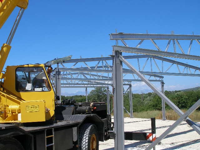 Crane lifting galvanized trusses on the project in Chorepiskopi, Corfu