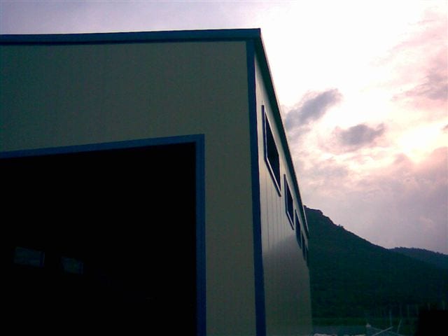 Corner detail with panels and base trim at the agricultural storage building in Kaisari