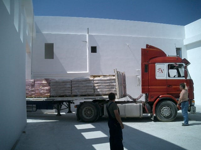 Unloading materials from a truck at the carpentry workshop site in Filoti, Naxos