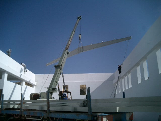 Lifting a roof beam by crane at the carpentry workshop in Filoti, Naxos