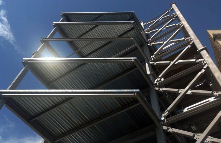 Steel frame of a multi-story building with cross bracing and composite slab deck sheets, Neuropublic project