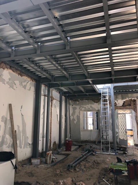 The mezzanine steel deck was set within the beam webs because of the limited height. A fairly difficult solution