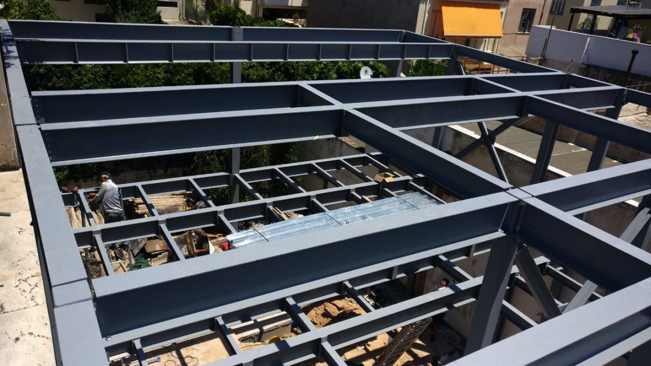 Steel frame of a two-story steel and concrete building in Ano Petralona, from above