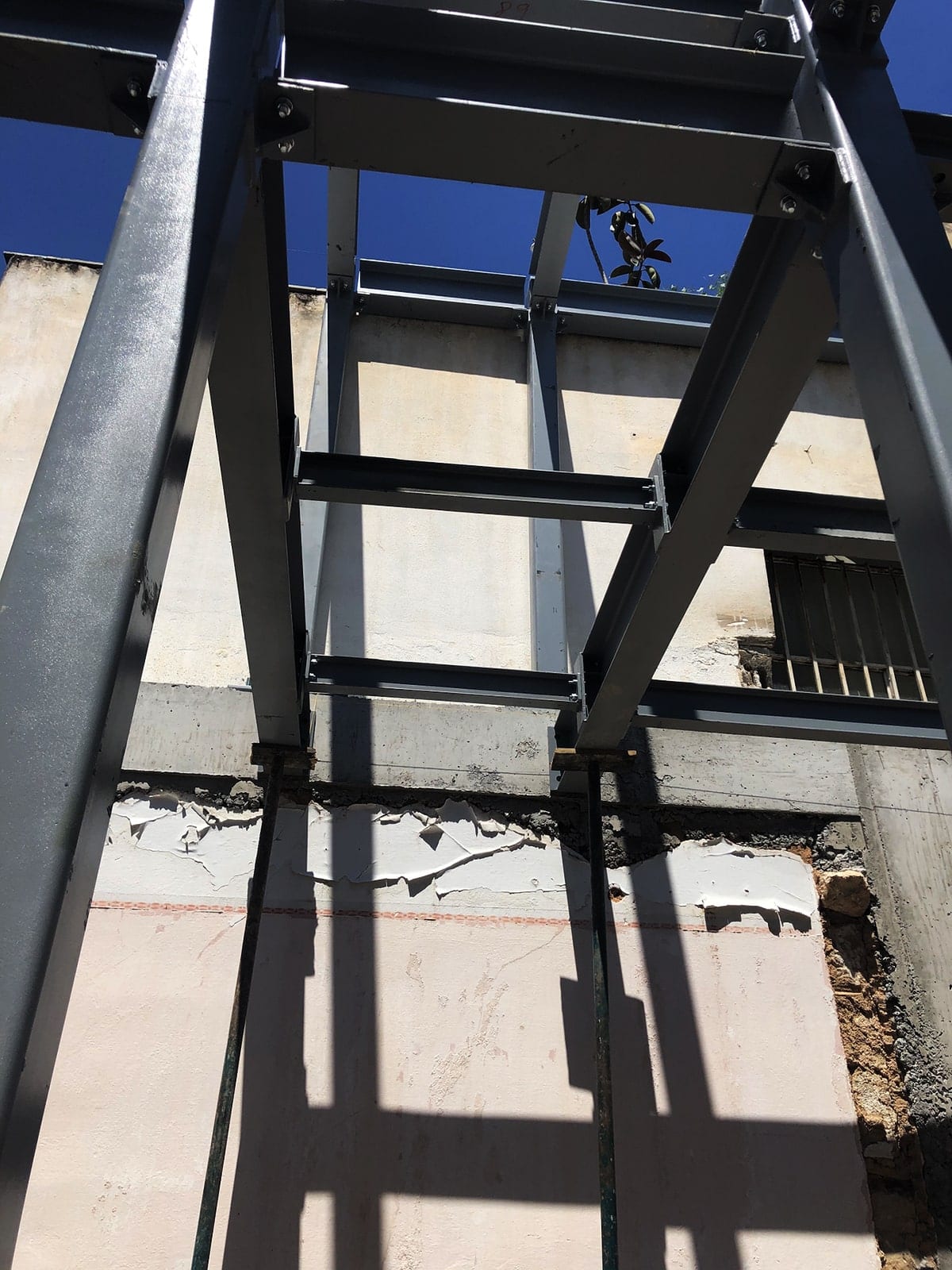 Detail of the steel frame connection to an existing wall in Ano Petralona
