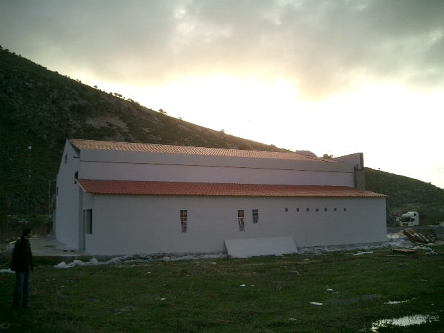 Completed building with a tile-profile roof at the venue in Plataria, Thesprotia