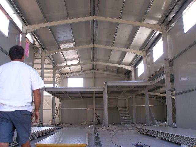 Interior of the distillery in Paramythia with a steel mezzanine, stairs and insulated panels