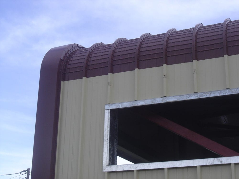 Detail of the curved roof and wall cladding trim at the cattle barn in Selefkeia