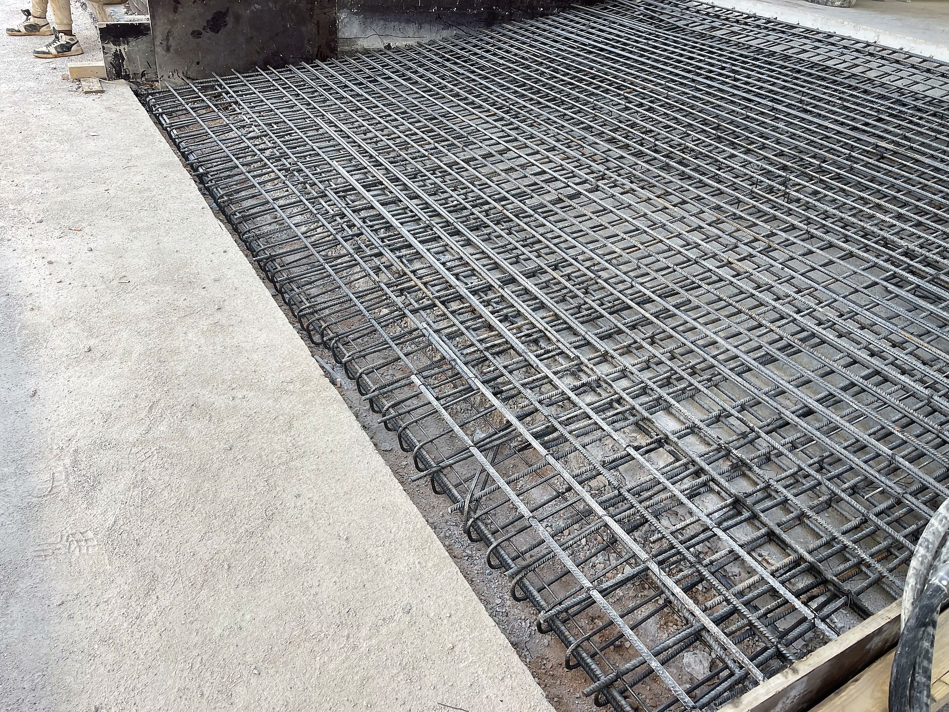 Double layer of foundation rebar before pouring concrete, industrial building extension in Aspropyrgos, Attica