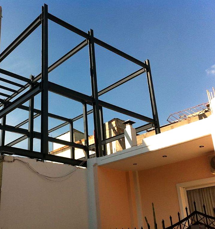 Two-story steel frame of a vertical addition on top of an existing single-story house in Dasos Chaidariou