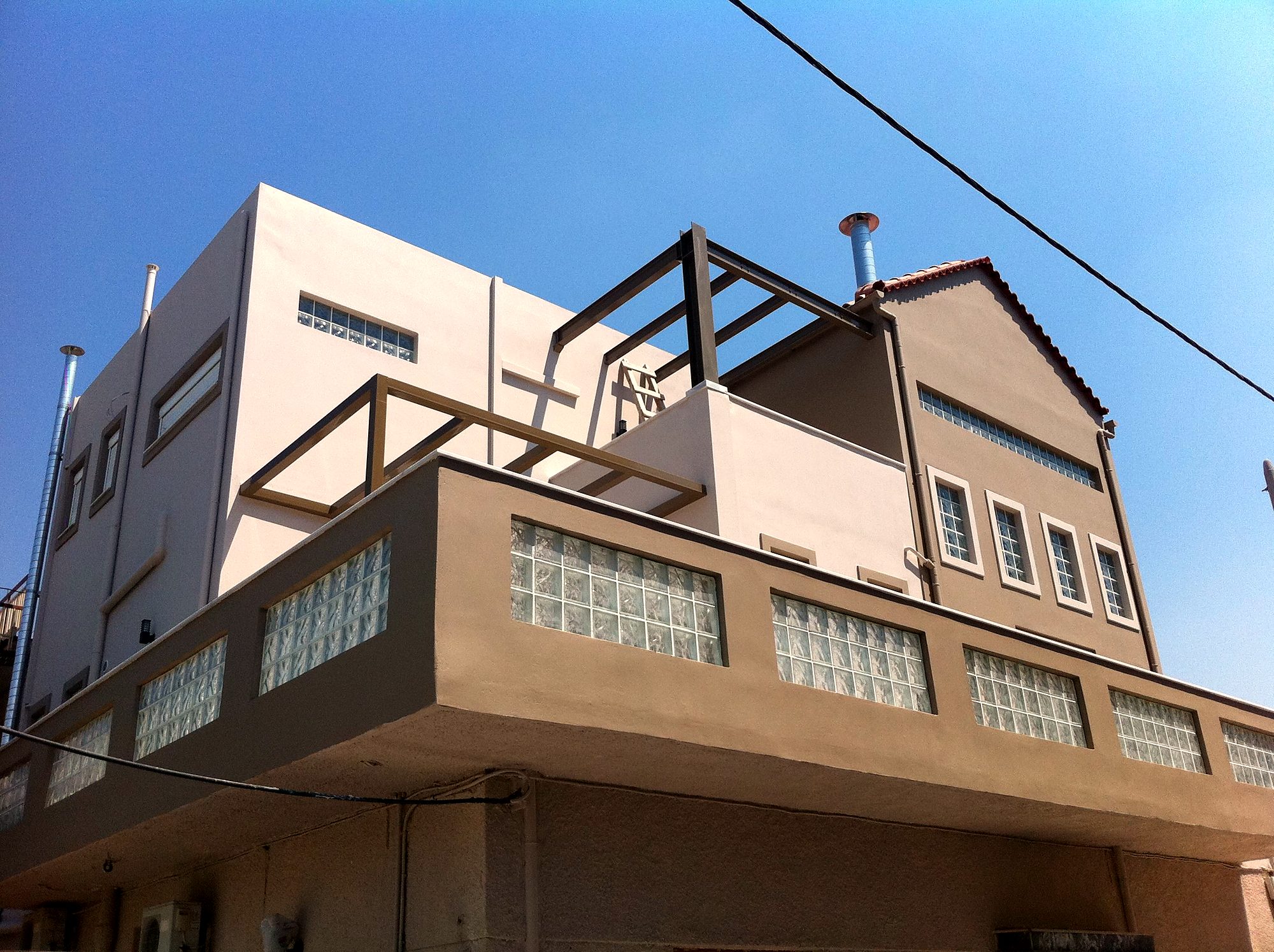 Completed two-story vertical addition with a steel frame and pergolas in Dasos Chaidariou, Attica