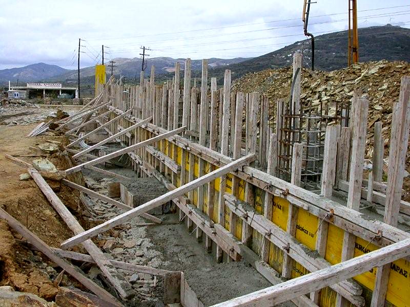 Formwork and shoring for the foundation walls before the concrete pour, steel building in Karystos, Evia