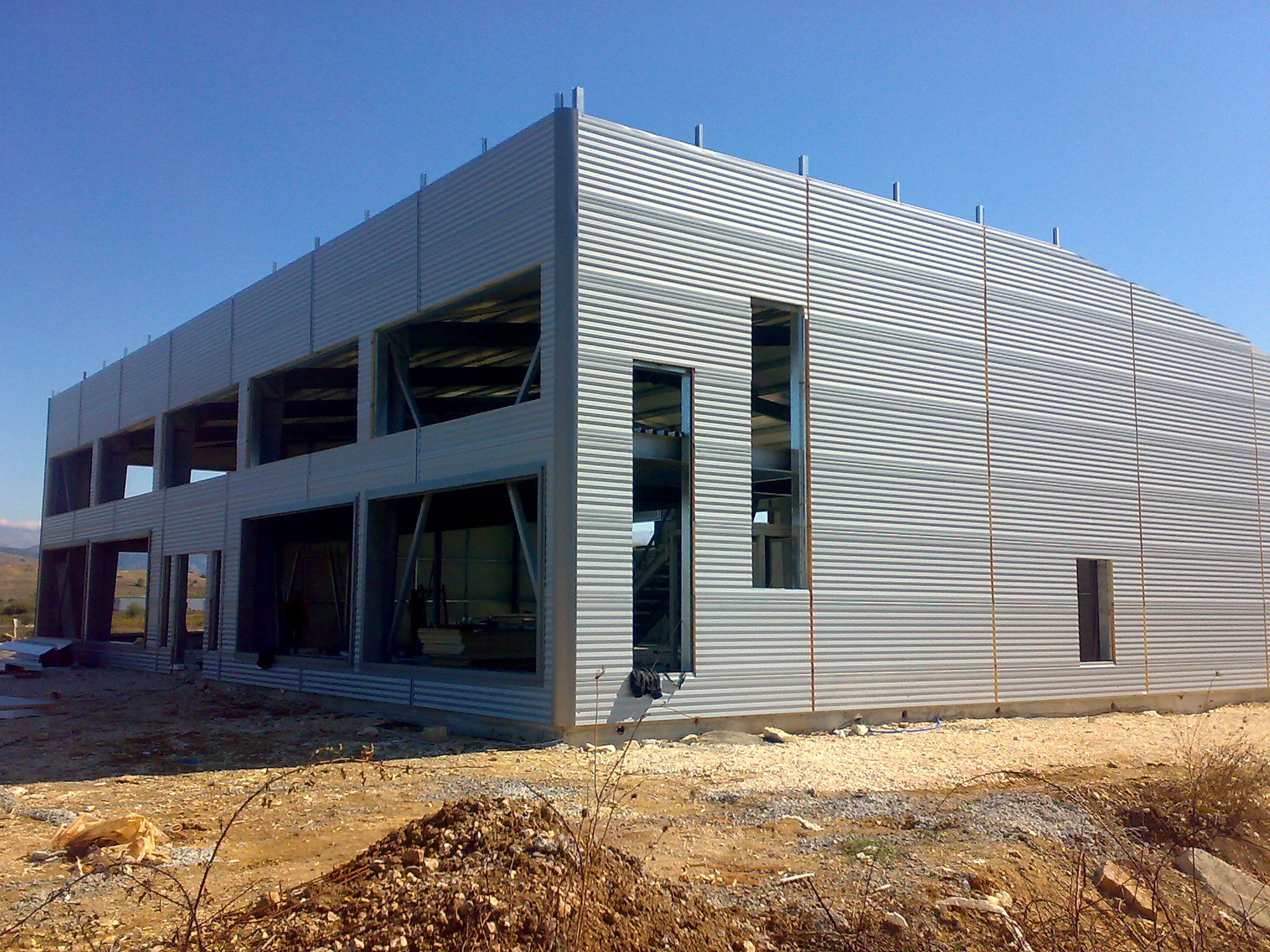 Two-story steel workshop building with completed panel wall cladding in Bafra, Ioannina