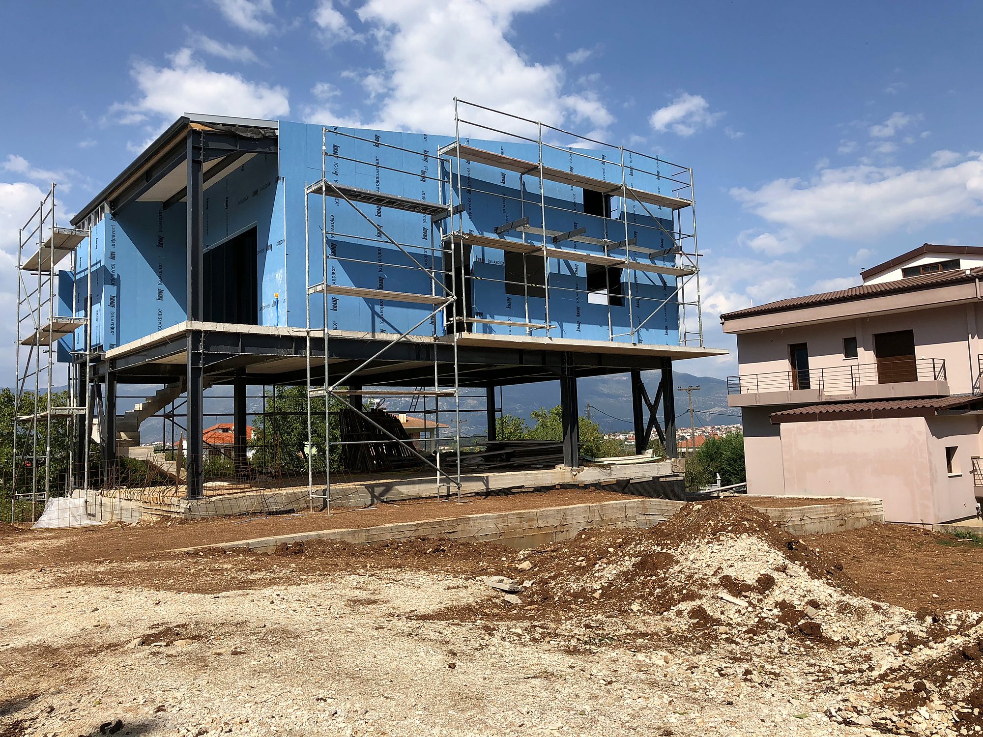 Exterior walls with a drywall system, with scaffolding, on a steel-frame house in Neochoropoulo, Ioannina