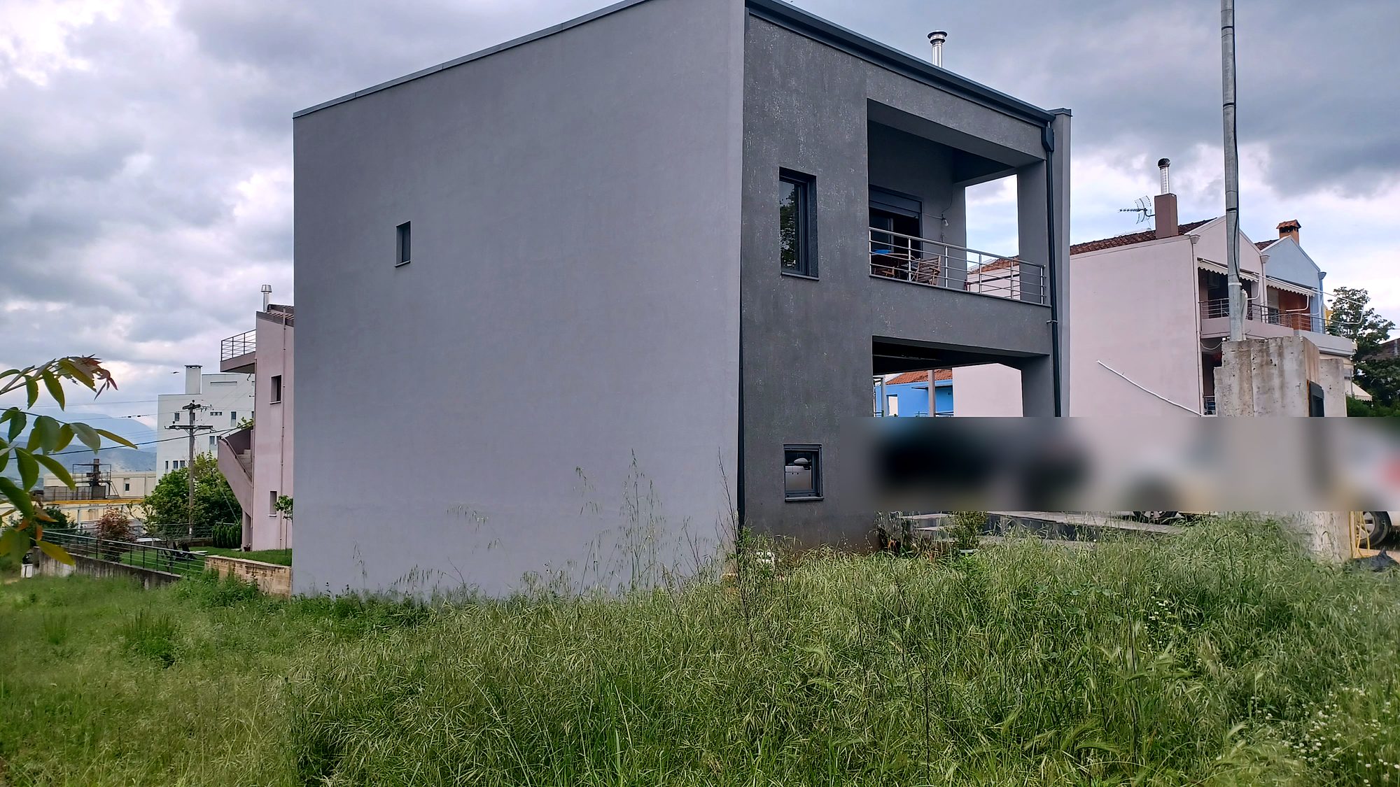 Side elevation of a completed two-story steel-frame house with a drywall system, Neochoropoulo, Ioannina