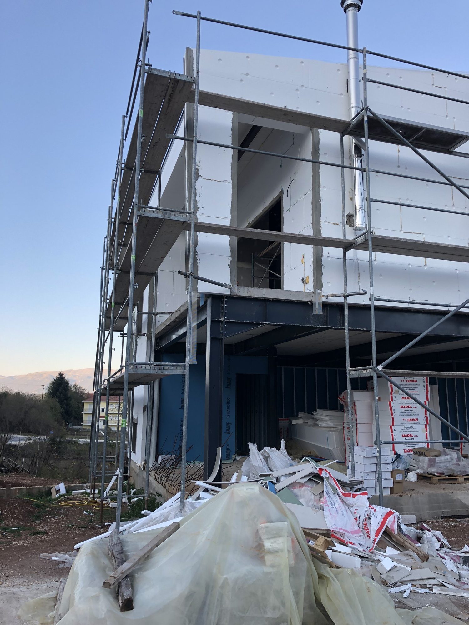 Applying the ETICS external thermal insulation, House with basement, pilotis and attic in Neochoropoulo, Ioannina