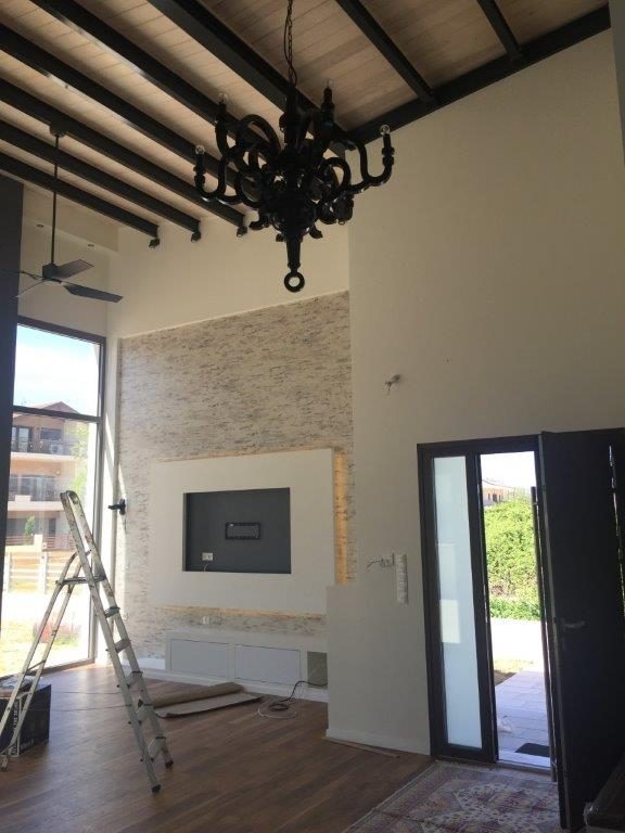 The double-height space with the exposed roof, house in Ioannina