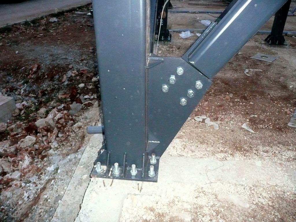 Steel column base with anchor bolts and a bolted gusset plate for the diagonal, building in Kefalonia