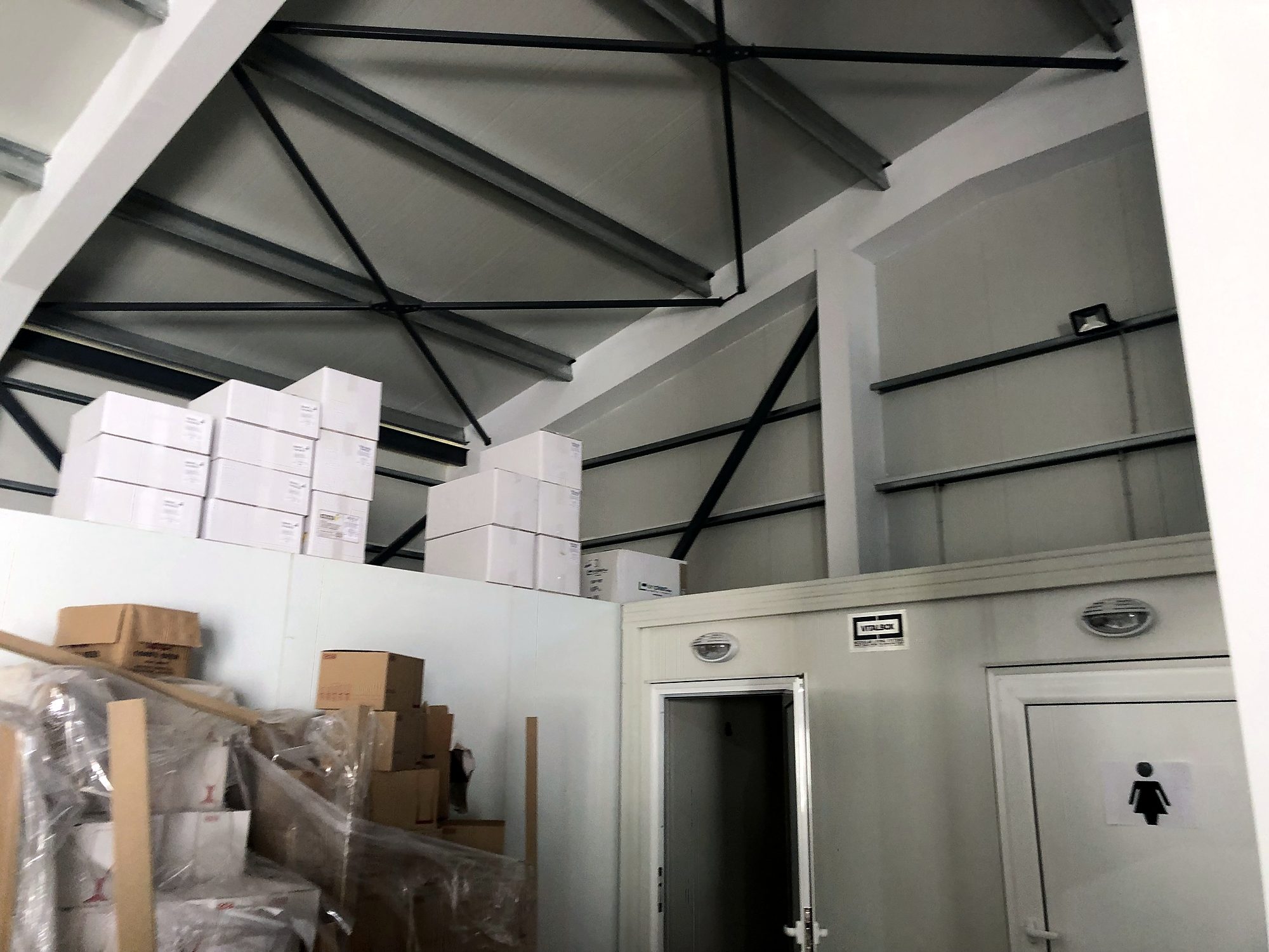 Interior of a steel food warehouse with exposed trusses in Arillas, Corfu
