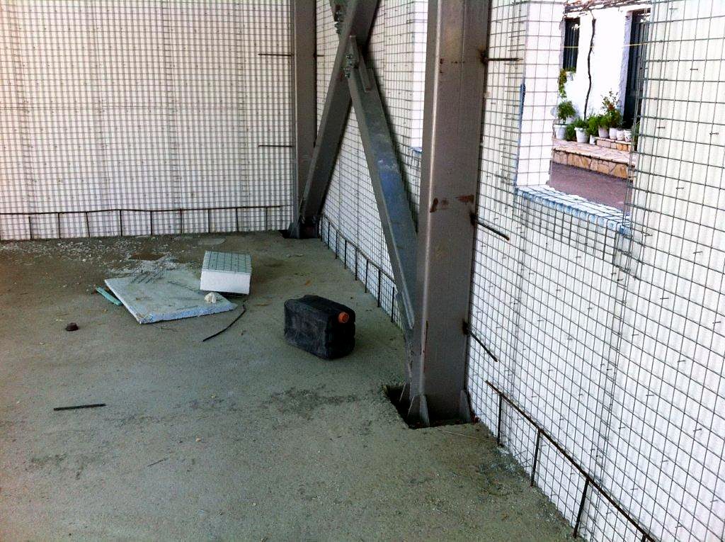 Steel column and diagonal brace inside a wall with steel mesh, Vlychos, Lefkada