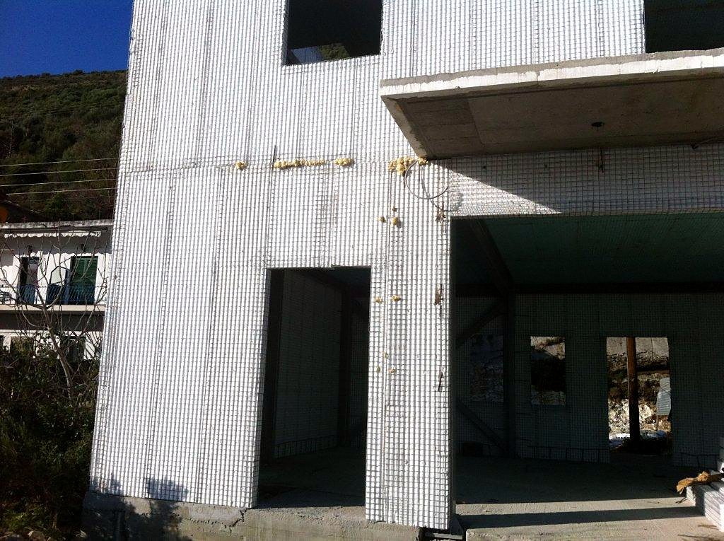 Exterior walls with steel mesh before plastering, bakery workshop and store in Vlychos, Lefkada