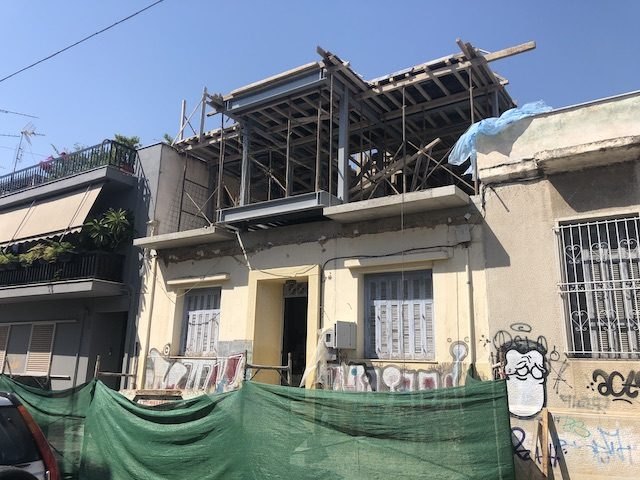 The front facade of the old building, which was retained, two-story steel and concrete building in Ano Petralona