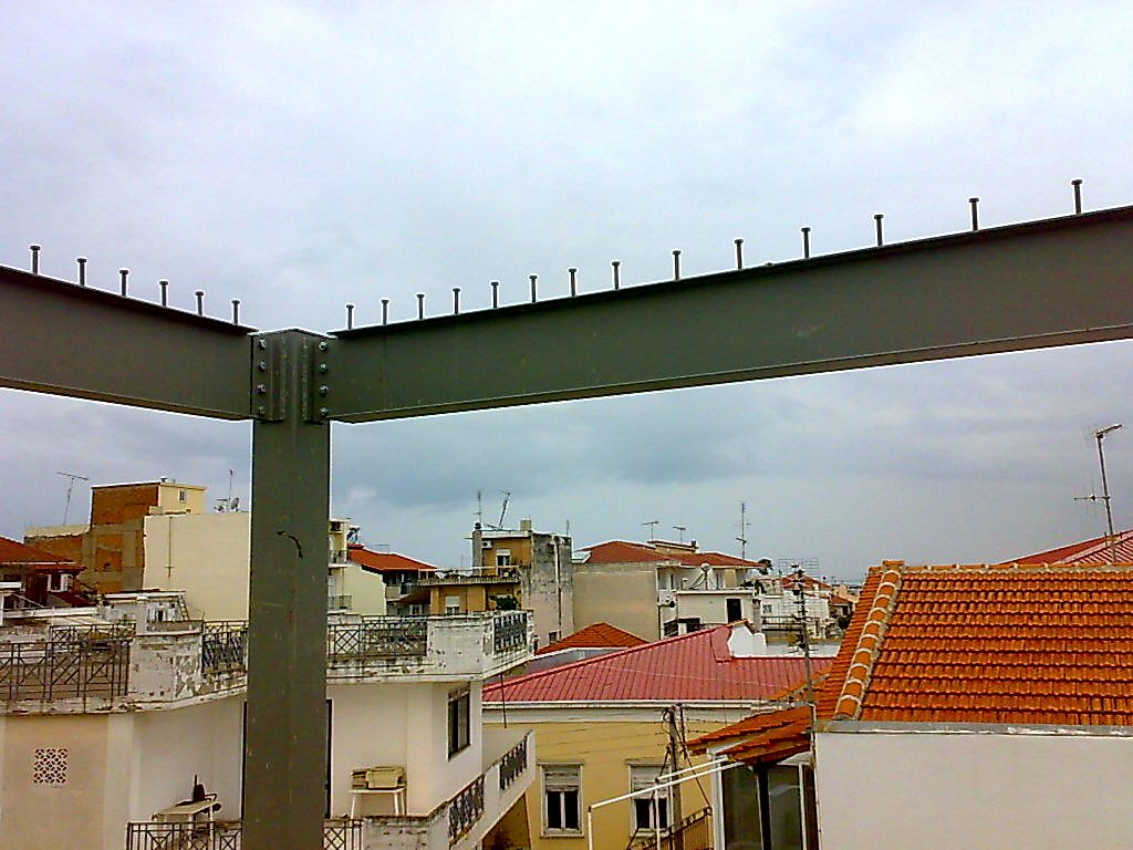 Bolted connection of steel beams with shear studs to a column, apartment building in Missolonghi