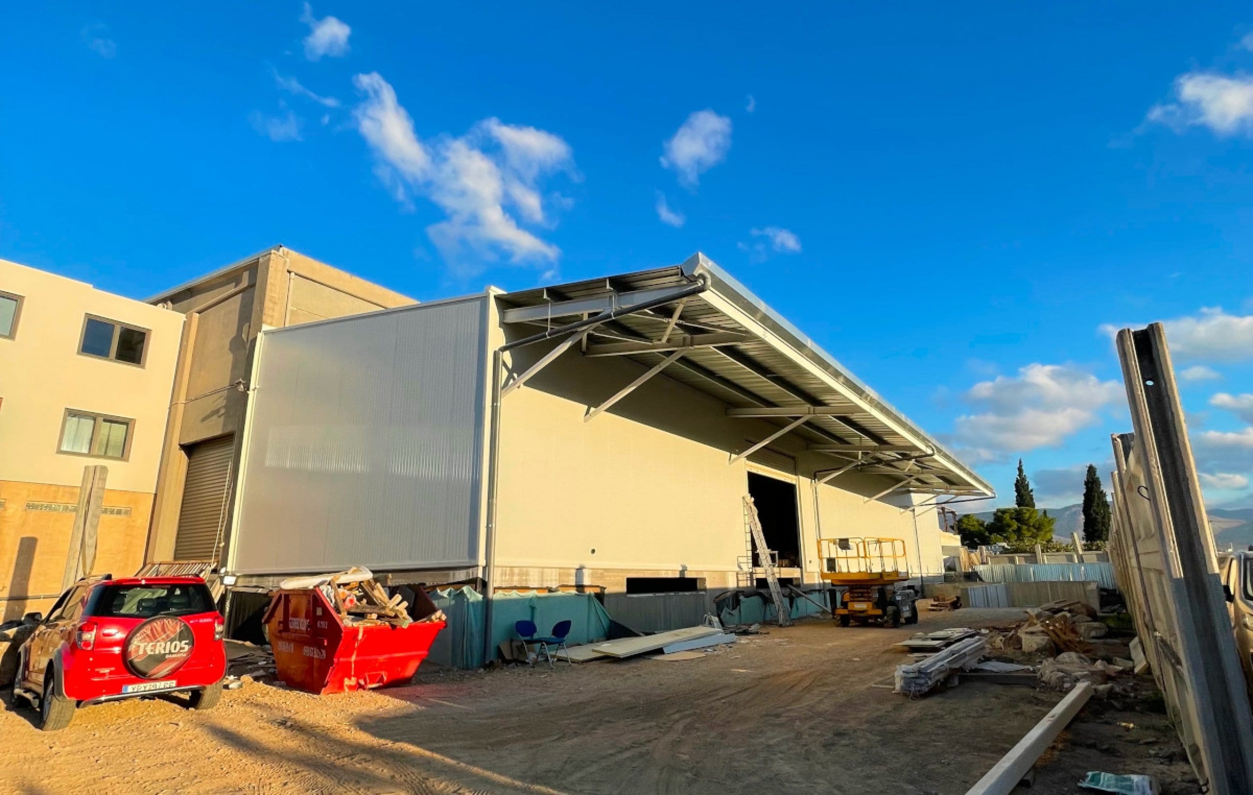 Completed steel building with panels and canopy for Kanellopoulos Wood & Materials